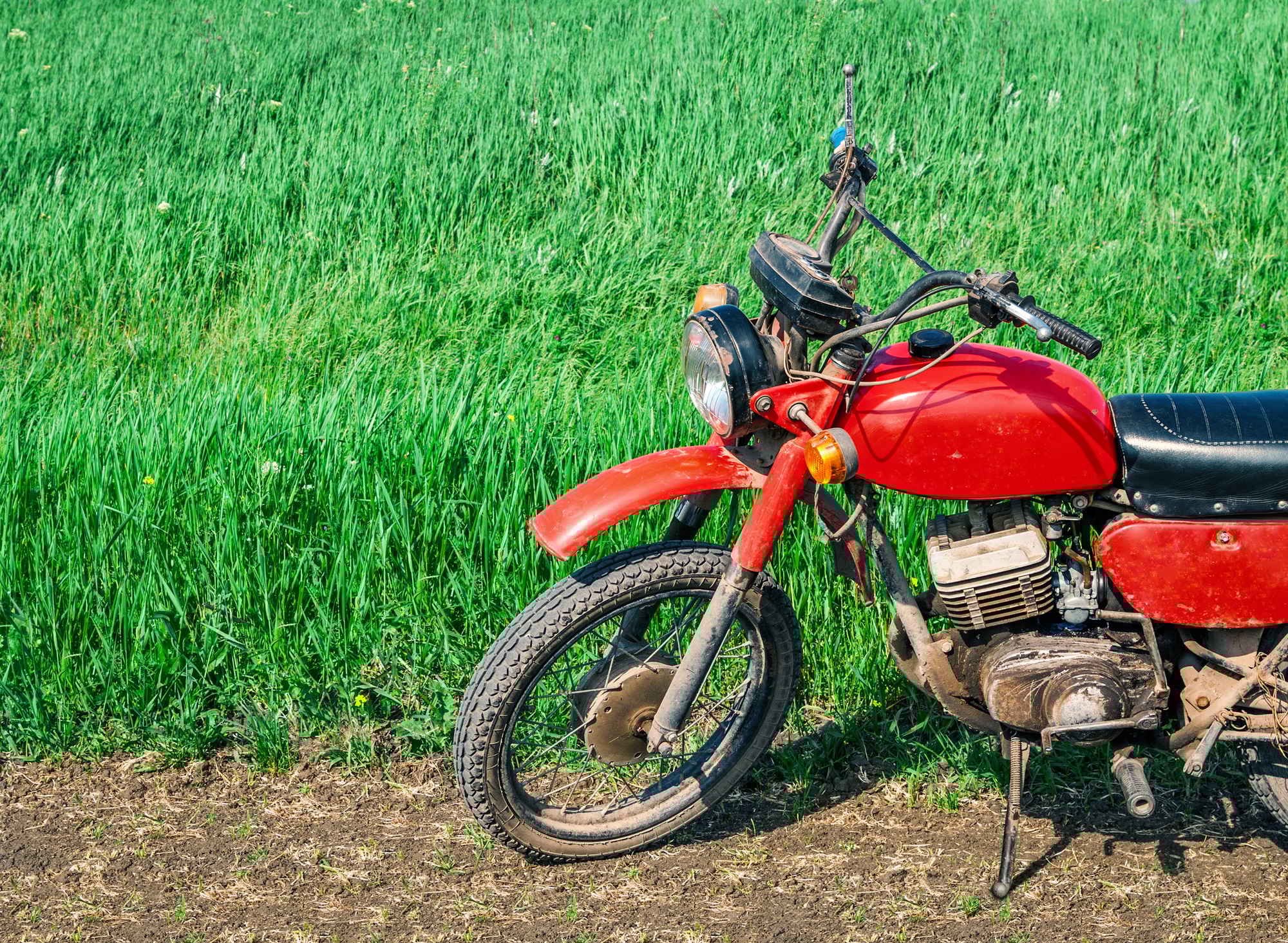 Classic old motorcycle on a dirt road